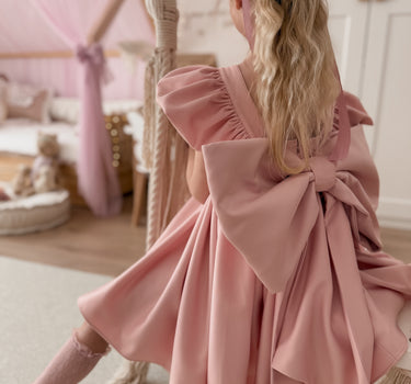 Back view of Grace Blush dress with oversized bow