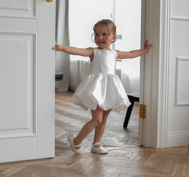Side angle of Bella bow white flower girl dress handmade in mikado