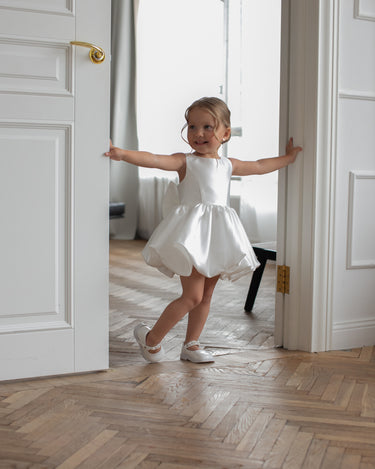 Side angle of Bella bow white flower girl dress handmade in mikado
