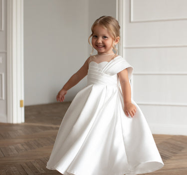 Girl twirling in the Elise white mikado flower girl gown