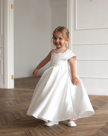 Girl twirling in the Elise white mikado flower girl gown