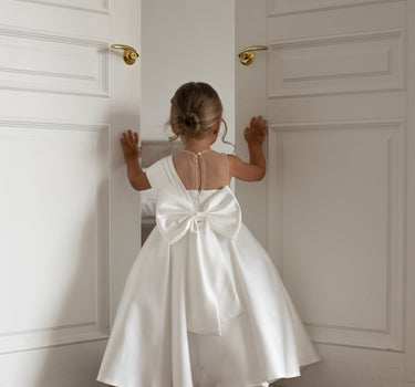 Little girl wearing the Elise gown, back view, white mikado flower girl dress
