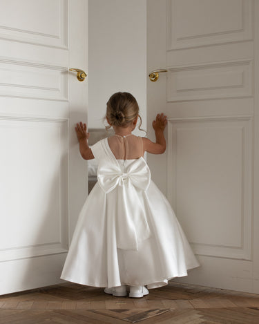 Little girl wearing the Elise gown, back view, white mikado flower girl dress