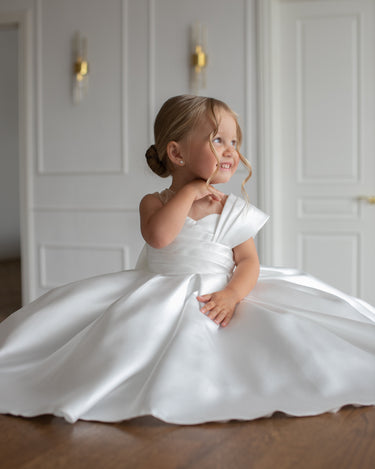 side view of the Elise mikado gown with pleated skirt