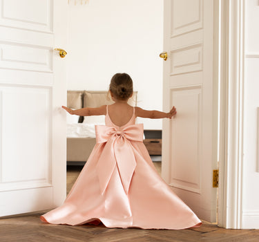 Little girl wearing luxury mikado flower girl gown in full length