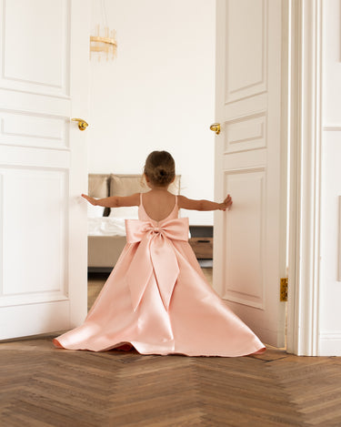 Little girl wearing luxury mikado flower girl gown in full length