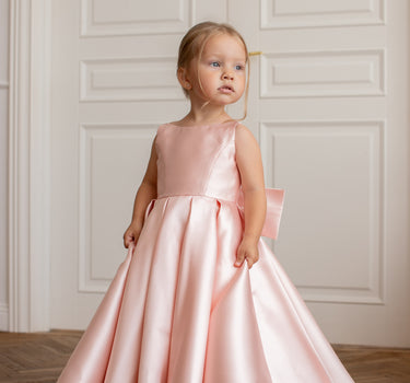 Little girl wearing luxury mikado flower girl gown in full length front view