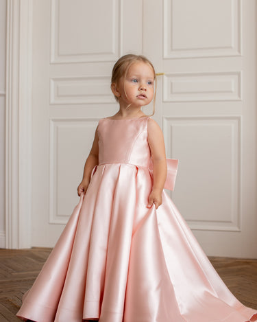 Little girl wearing luxury mikado flower girl gown in full length front view