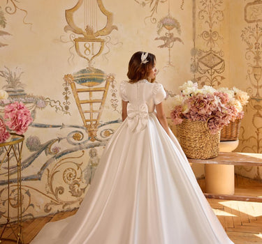 Back view of the Isabella handmade gown showing large satin bow detail