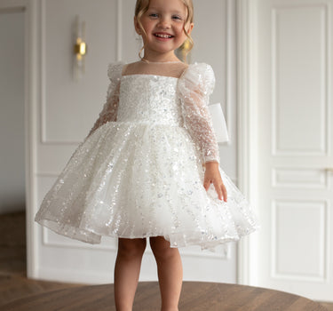 Child in luna sequin dress twirling, sequin tulle skirt spread beautifully 