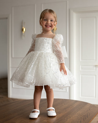 Child in luna sequin dress twirling, sequin tulle skirt spread beautifully 