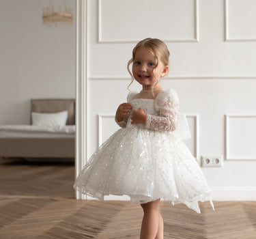 Side angle of the luna sequin dress with mesh long sleeves and square neckline