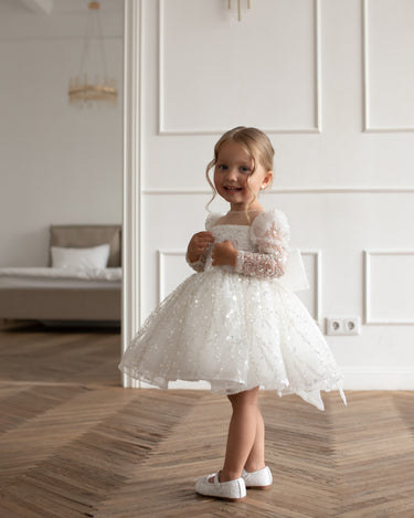 Side angle of the luna sequin dress with mesh long sleeves and square neckline