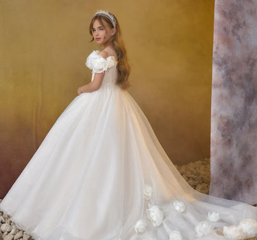 Little girl wearing the Maison luxury sparkly off shoulder flower girl gown with full skirt and train