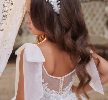 Back view of the Elara Dress with sheer back and statement bows