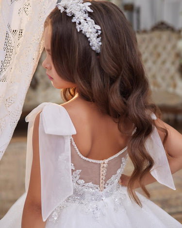 Back view of the Elara Dress with sheer back and statement bows