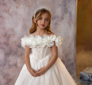 Maison sparkly flower girl gown showing full silhouette and shimmering fabric.