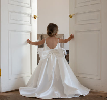 Little flower girl wearing the Majestic Mikado full length satin flower girl gown