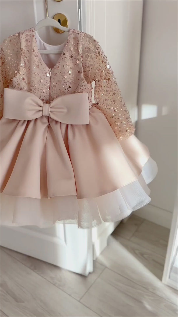 Close up video of Isla Belle dress showing sequin details and bow.