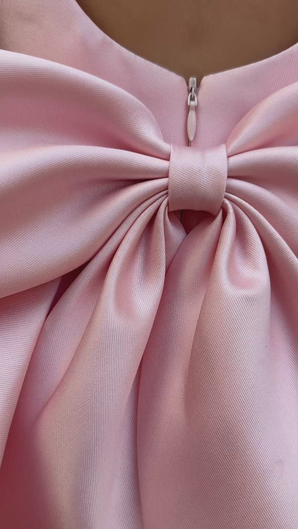 Little girl at an event wearing the Majestic Mikado Dress in blush with a large satin bow video