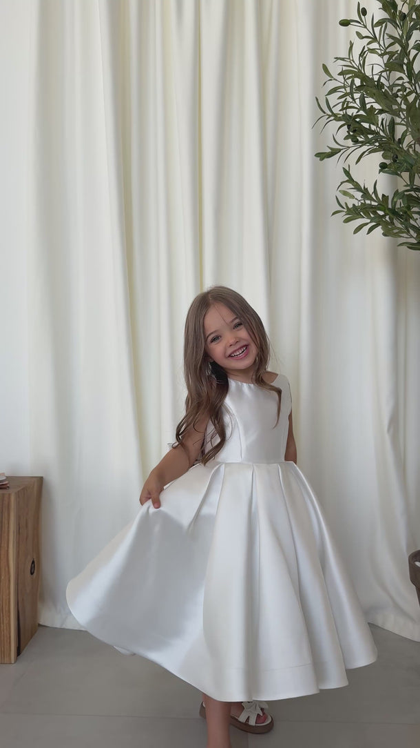 Girl smiling and twirling in the Majestic Mikado Dress by Aylu Bebe video